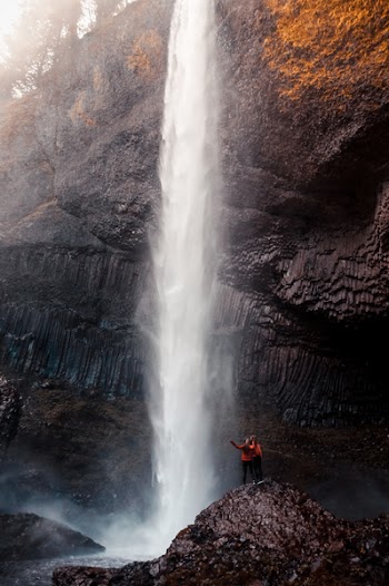 Two Man Beside Waterfall Taken At Daytime