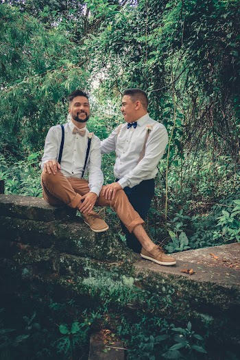 Two Man Sitting and Standing Outdoors