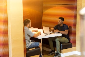 Two Man Sitting Beside Table