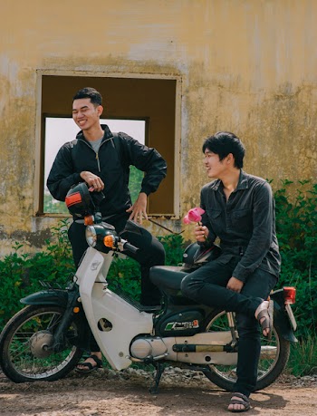 Two Man Standing Near White and Black Underbone Motorcycle