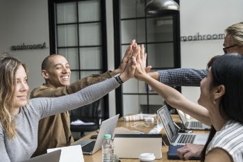 Two Men And Two Women Giving Highfives