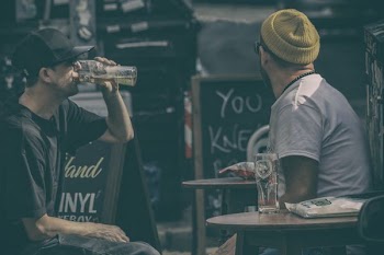 two men drinking beers