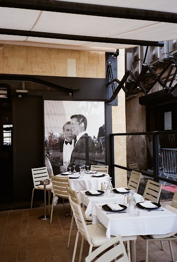 Two Men in Black Suit Jackets Poster In A Restaurant