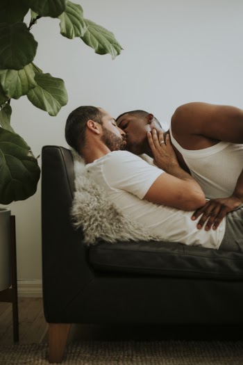 Two Men Kissing Each Other on Couch