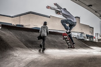 Two Men On Skate Park