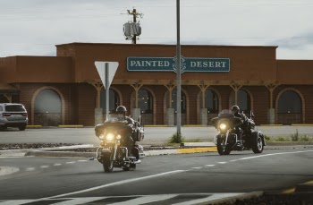 Two Men Riding on Touring Motorcycle Near Painted Desert Store