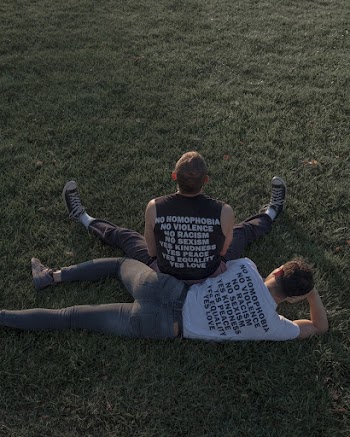 Two Men Sitting and Lying on Grass