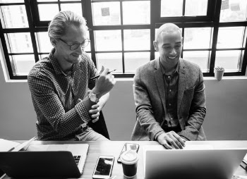 Two Men Sitting on Chair Beside Table