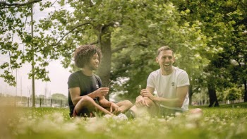 Two Men Sitting on Grass