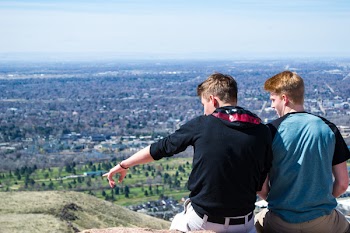 Two Men Sitting on Hill