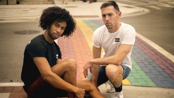 Two Men Sitting on Road