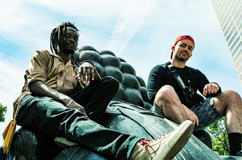 Two Men Sitting on Statue