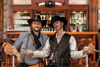 Two Men Standing Beside Brown Wooden Cabinet