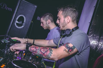 Two Men Standing in Front Dj Mixer