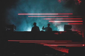 two men standing in front of smoke