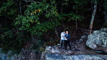 Two Men Standing Near Cliff