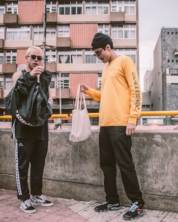 Two Men Standing Near Concrete Railings