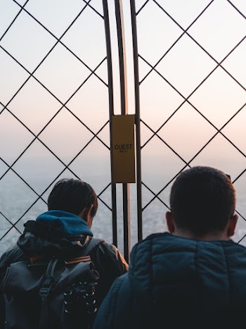 Two Men Standing Near Gate