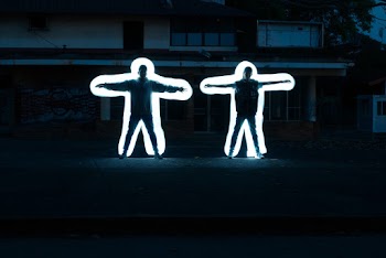 Two Men Standing Near White House at Night