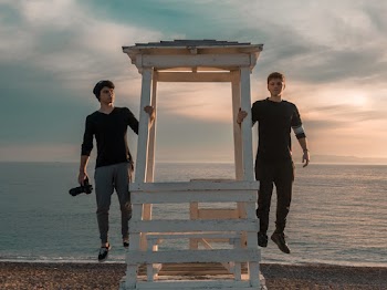 Two Men Standing On Lifeguard Tower