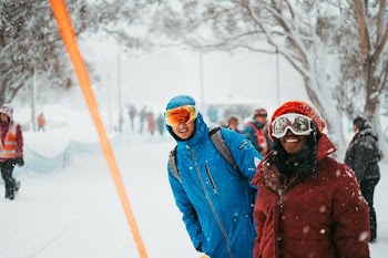 two men standing on snow covered field
