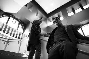 Two Men Standing on Stairs