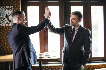 Two Men Standing While Doing High Five