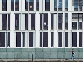 two men walking beside building