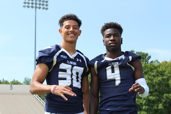 Two Men Wearing American Football Uniform Taking Photo Together