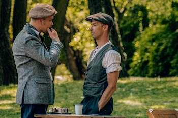 Two Men Wearing Suits and Talking to Each Other