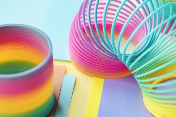 Two Multicolored Slinky Toys