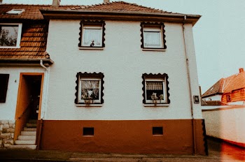 Two Opened Window on Brown and White Building