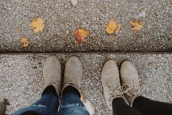 two pairs of brown leather Chukka boots and booties
