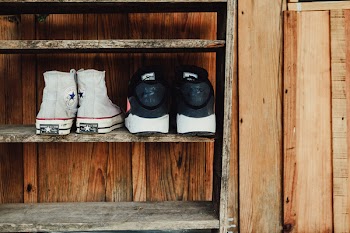 Two Pairs of Gray and Black Sneakers on Rack