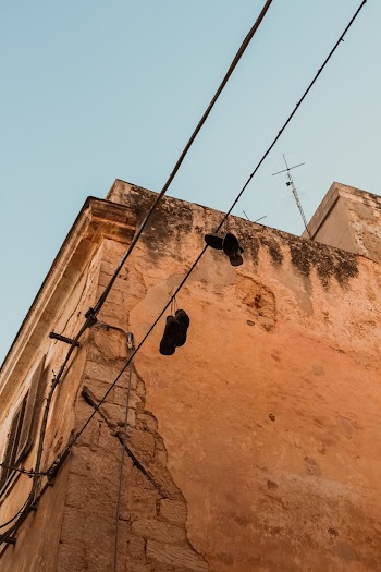 Two Pairs of Shoes Hanging on Electric Cable