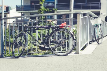Two Parked Bikes on Gray Metal Rails