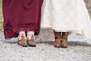 Two People Beside Each Other Each Wearing Cowboy Boots