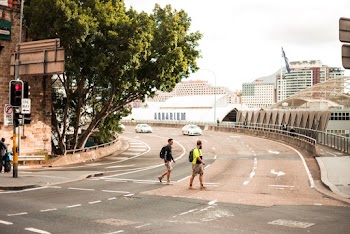 Two People Crossing The Street