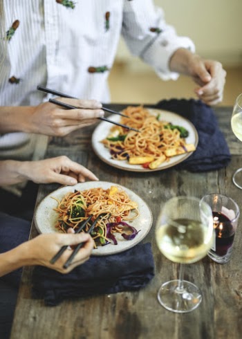 Two People Eating Noodles