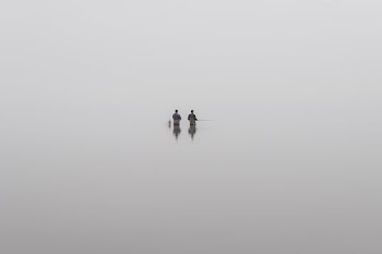 two people holding fishing rod in boat