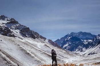 two people hugging on foot of snowy mountain