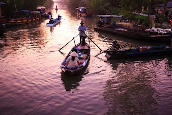 Two People on Boat in Body of Water