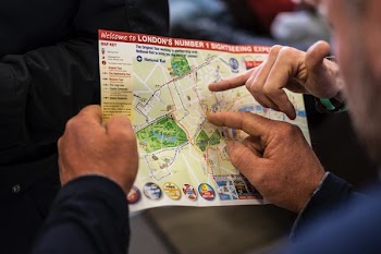 two people pointing at London's number one sightseeing map