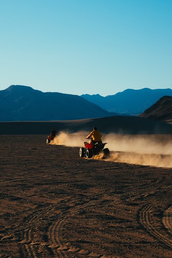 Two People Riding on All-terrain Vehicles