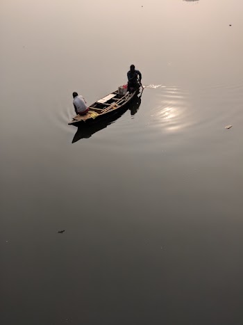 Two People Riding on Canoe during Daytime