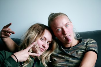 Two People Sitting On Couch