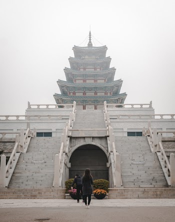 Two People Standing In Front Of Temple