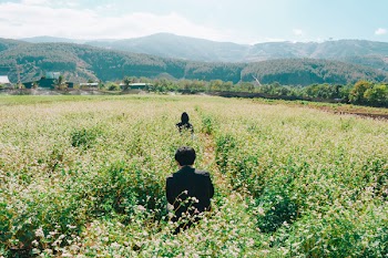 Two People Standing on Field