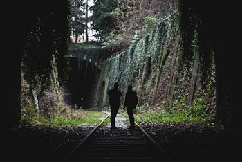 Two People Standing On Railway 