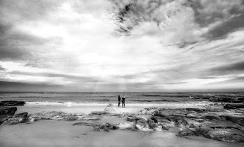 Two People Standing on Seashore